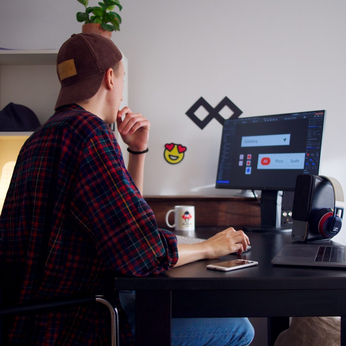 man sitting near table using computer